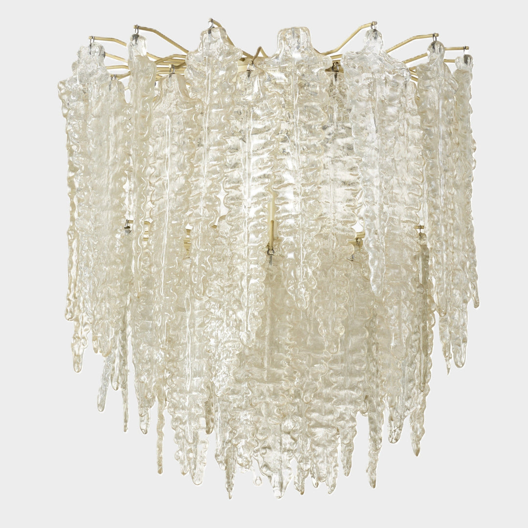 Clear Murano glass chandelier from Venini, with textured icicle-shaped elements suspended from a brass frame.
