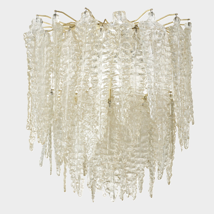 Clear Murano glass chandelier from Venini, with textured icicle-shaped elements suspended from a brass frame.