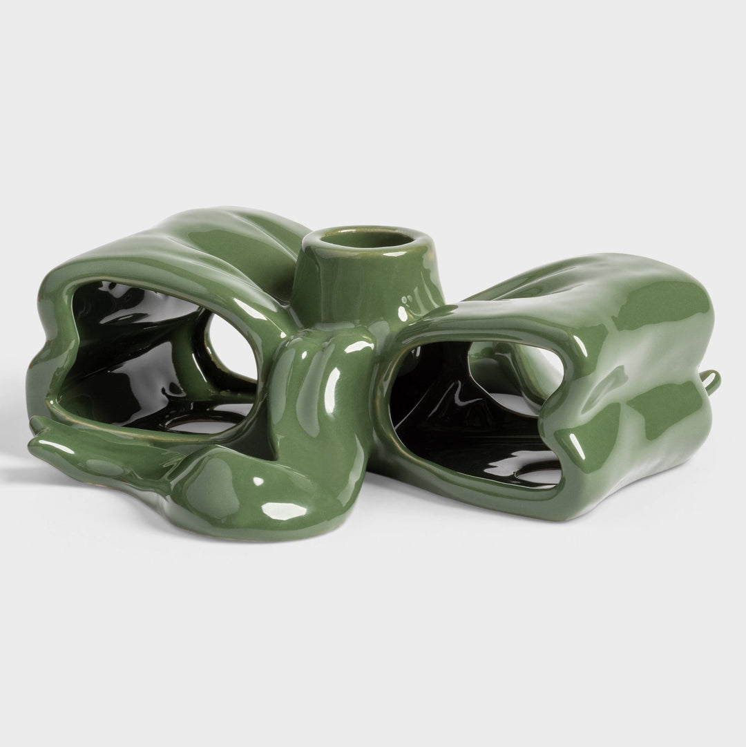 Green ceramic ribbon candle holder by &Klevering with a glossy finish and abstract geometric design.