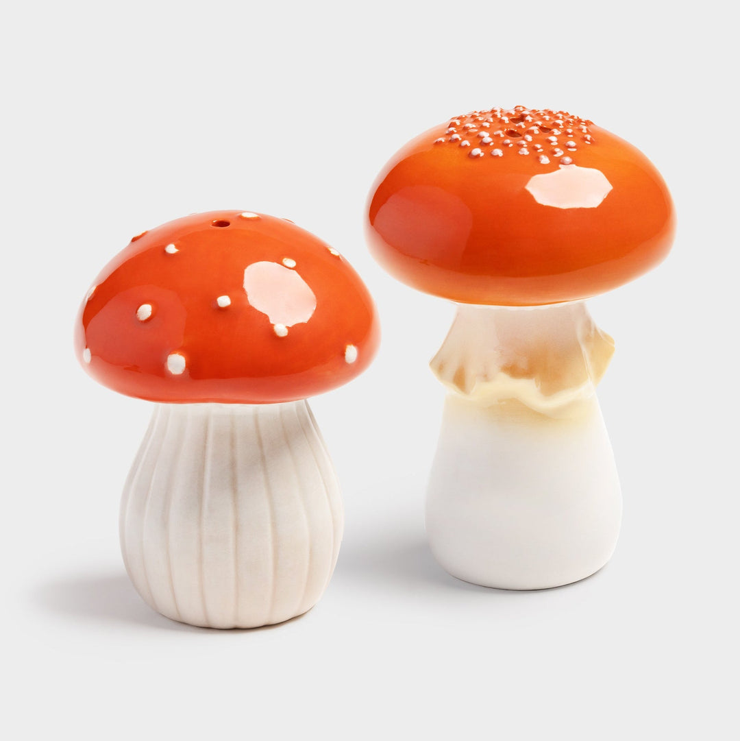 Ceramic mushroom salt and pepper shakers by &Klevering, featuring orange caps with white polka dots and ridged stems.
