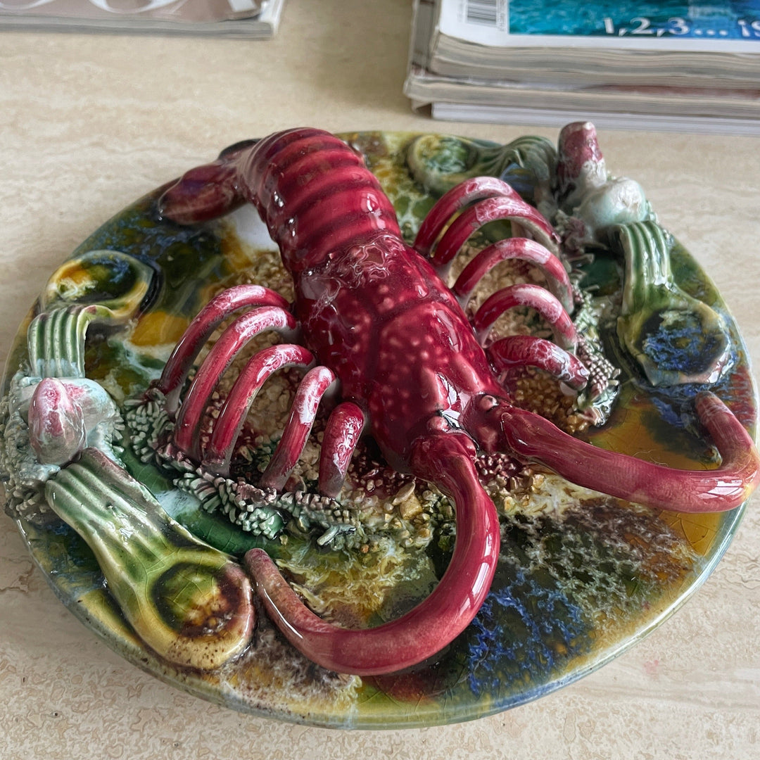 Majolica Palissy ware lobster from the 1940s featuring textured body and seaweed details.