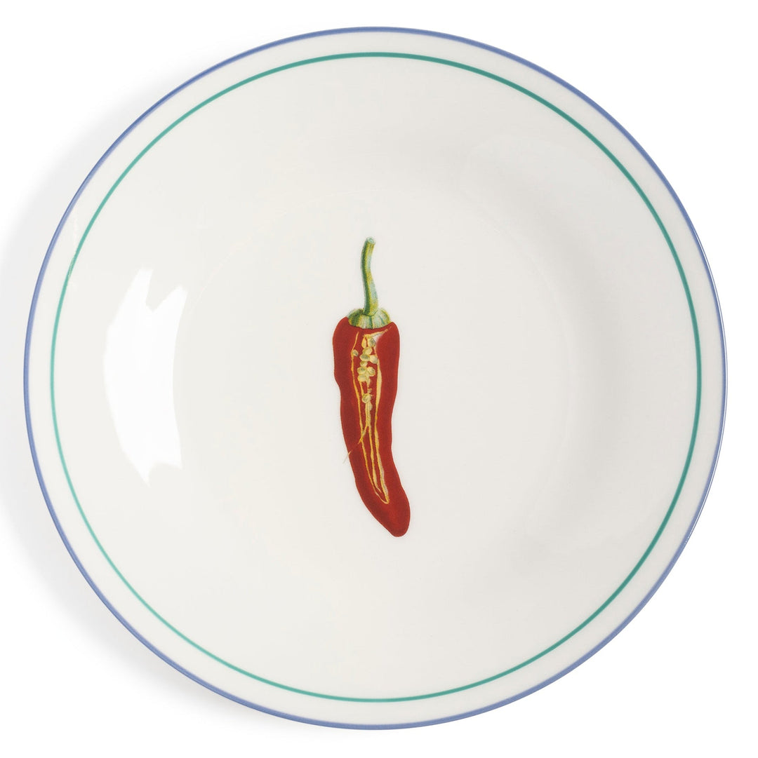 Vegetable plate by &Klevering with a chili pepper illustration, set against a white background with a green and blue rim.
