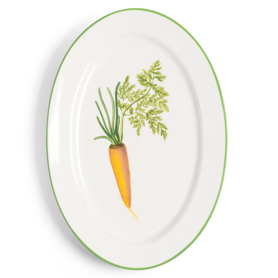 Serving plate with carrot design by &Klevering featuring a white background and green rim.
