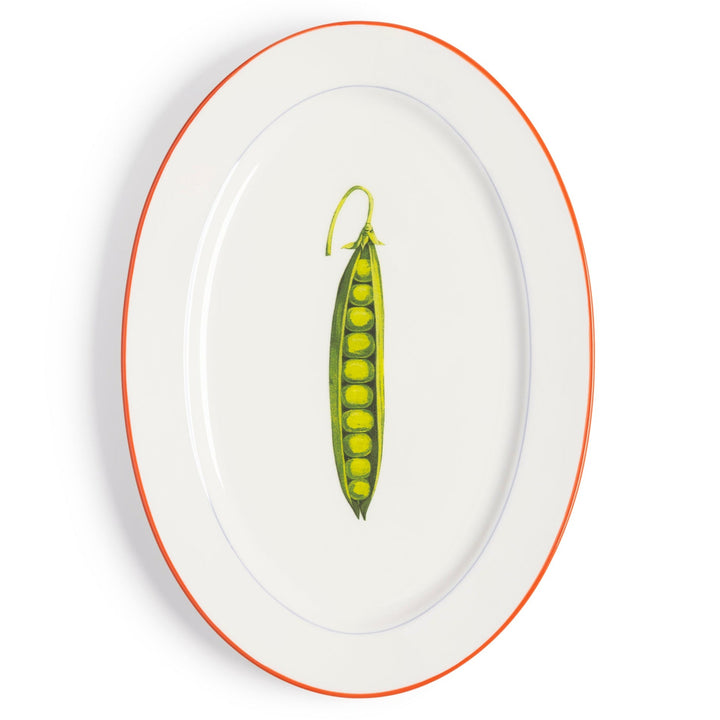 Serving plate with pea design by &Klevering, featuring a white background, orange rim, and oval shape.