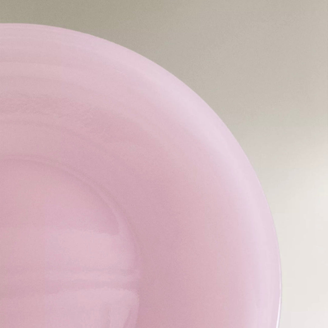 Pink dinner plate by Nanushka with a glossy finish.