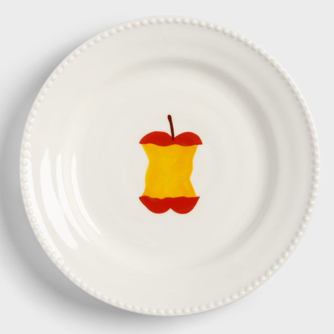 Decorative plate with an apple core design from &klevering, featuring a beaded rim.