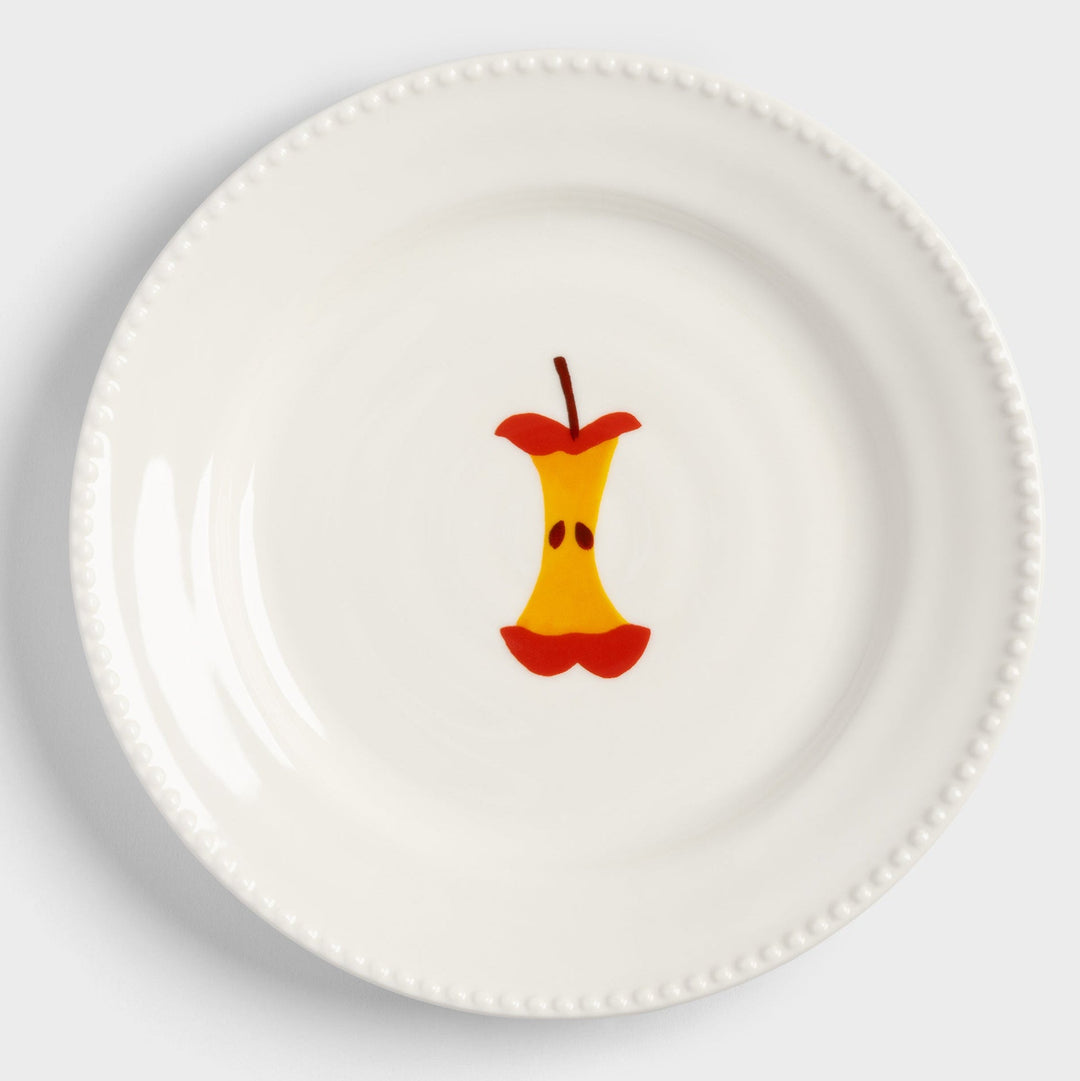 White plate with apple core design from &klevering, featuring a beaded border around the rim.
