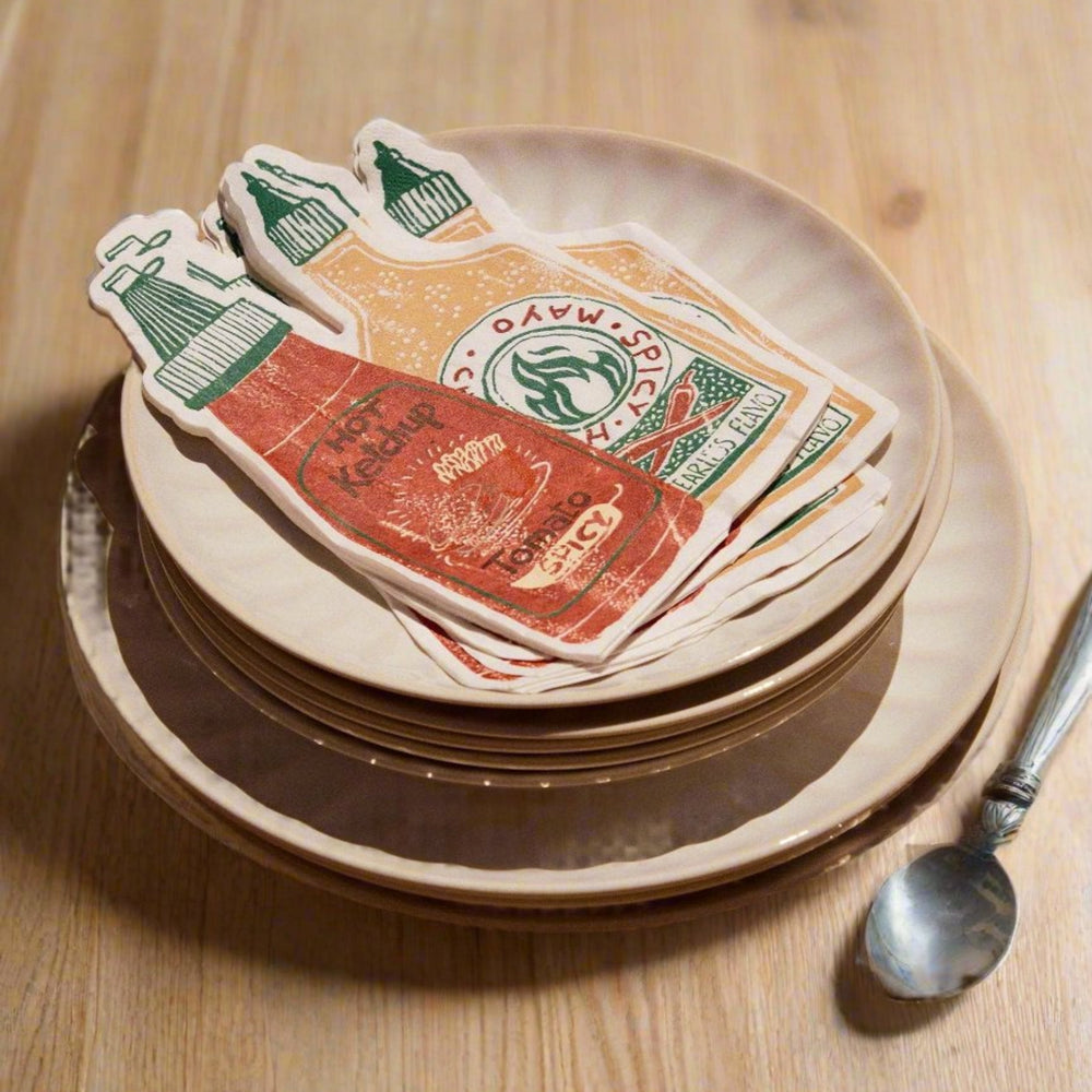 Sauces paper napkins pack of twenty with ketchup and mayonnaise prints on stacked plates.