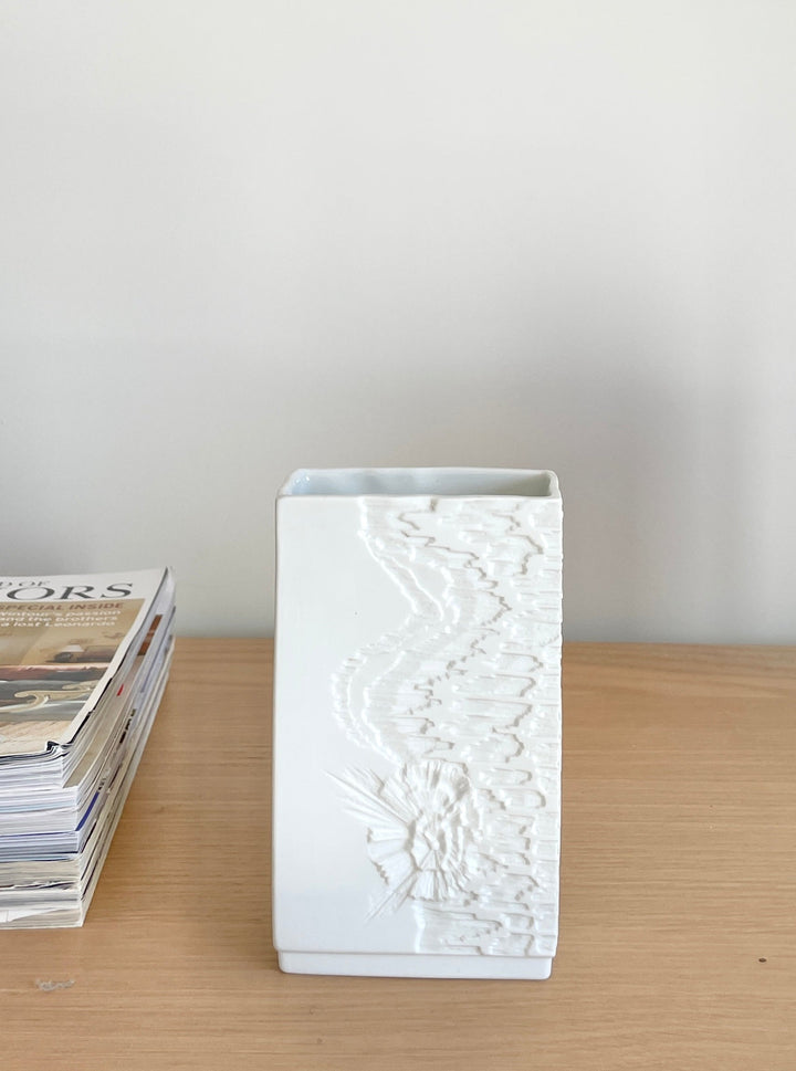 White rectangular porcelain vase by Kaiser, with a floral pattern and raised textured design.