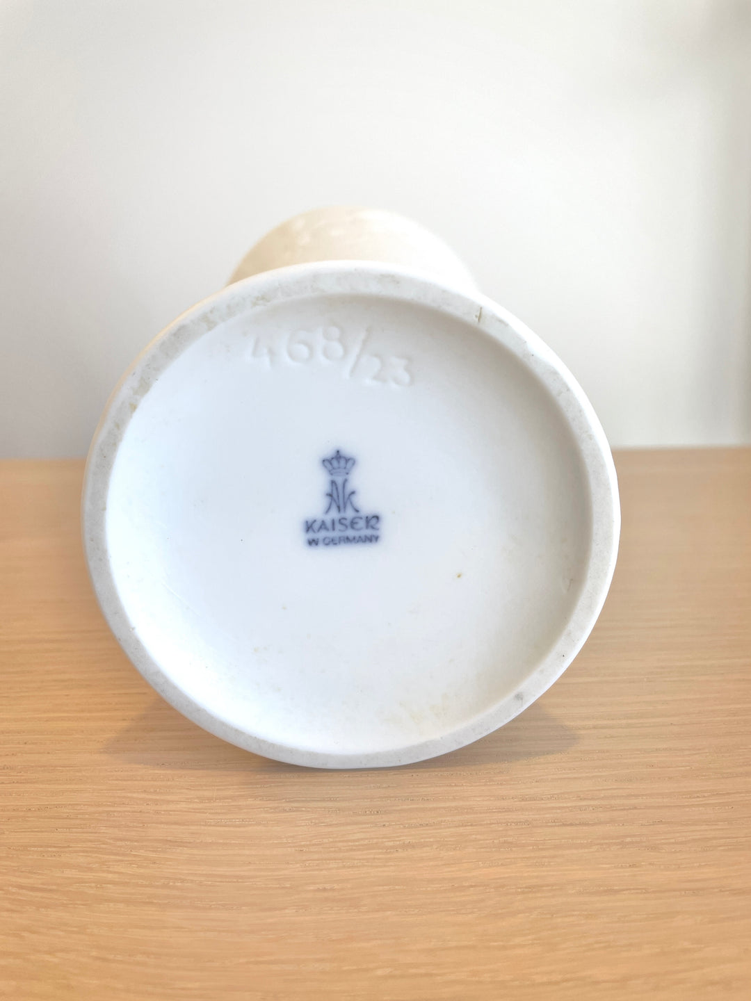 White porcelain vase by Kaiser with a visible maker's mark and imprinted serial number.
