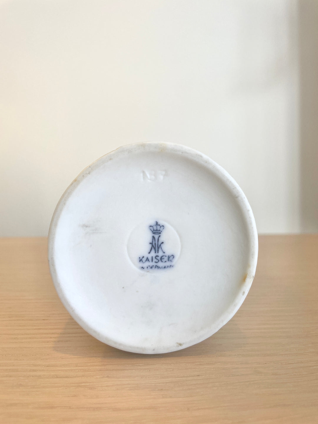White porcelain vase by Kaiser with a blue maker's mark on the base.