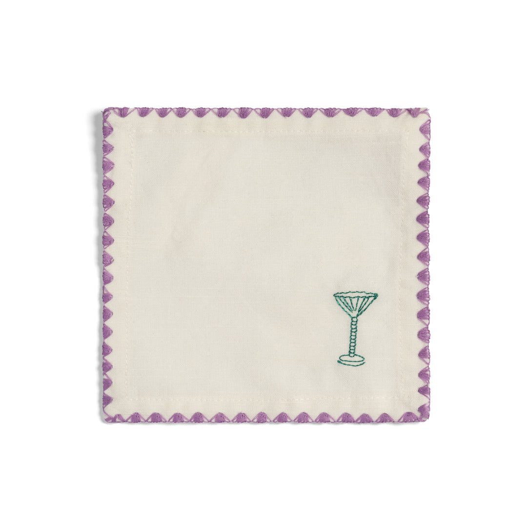 Set of four off-white cocktail napkins by &Klevering, featuring a green cocktail glass and lavender zigzag stitching.