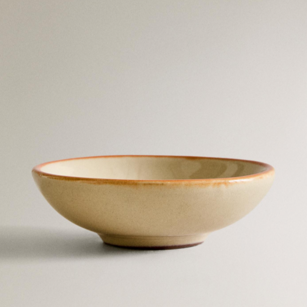 Painted earthware mini bowl by Nanushka with a beige glaze and brown rim.