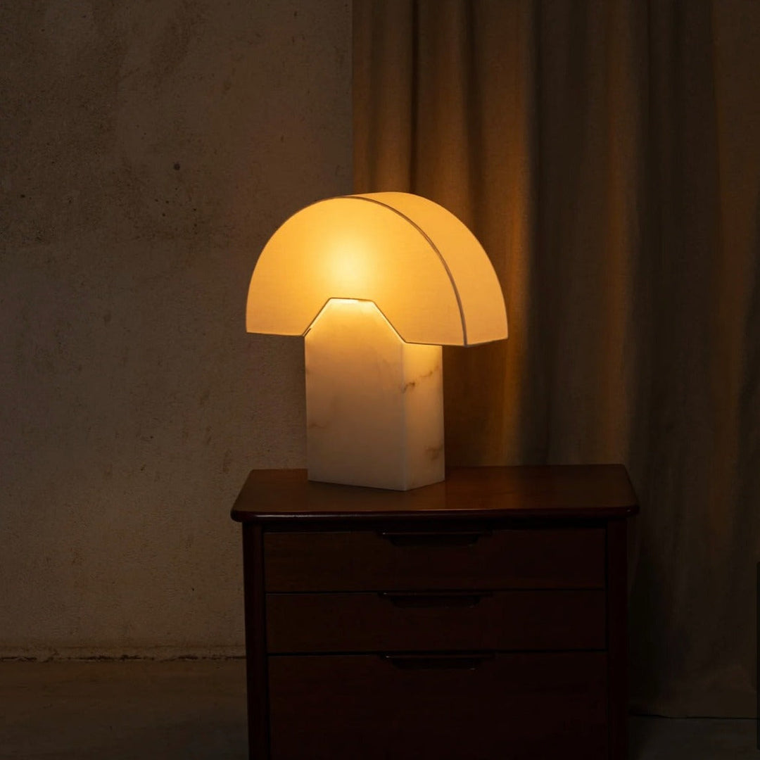 Alabaster table lamp from Simone and Marcel, illuminating a bedside table.