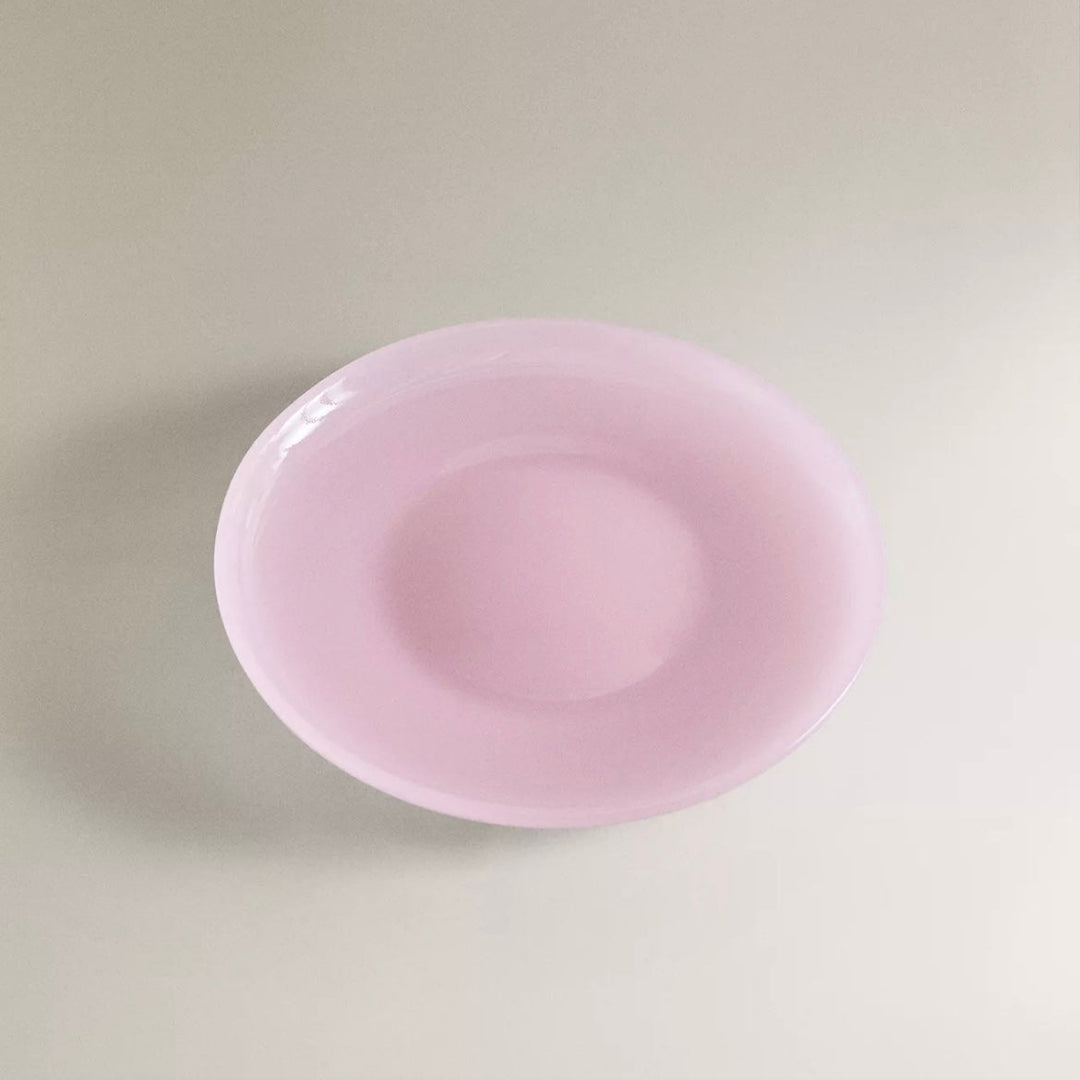 Pink dinner plate by Nanushka with a glossy finish.
