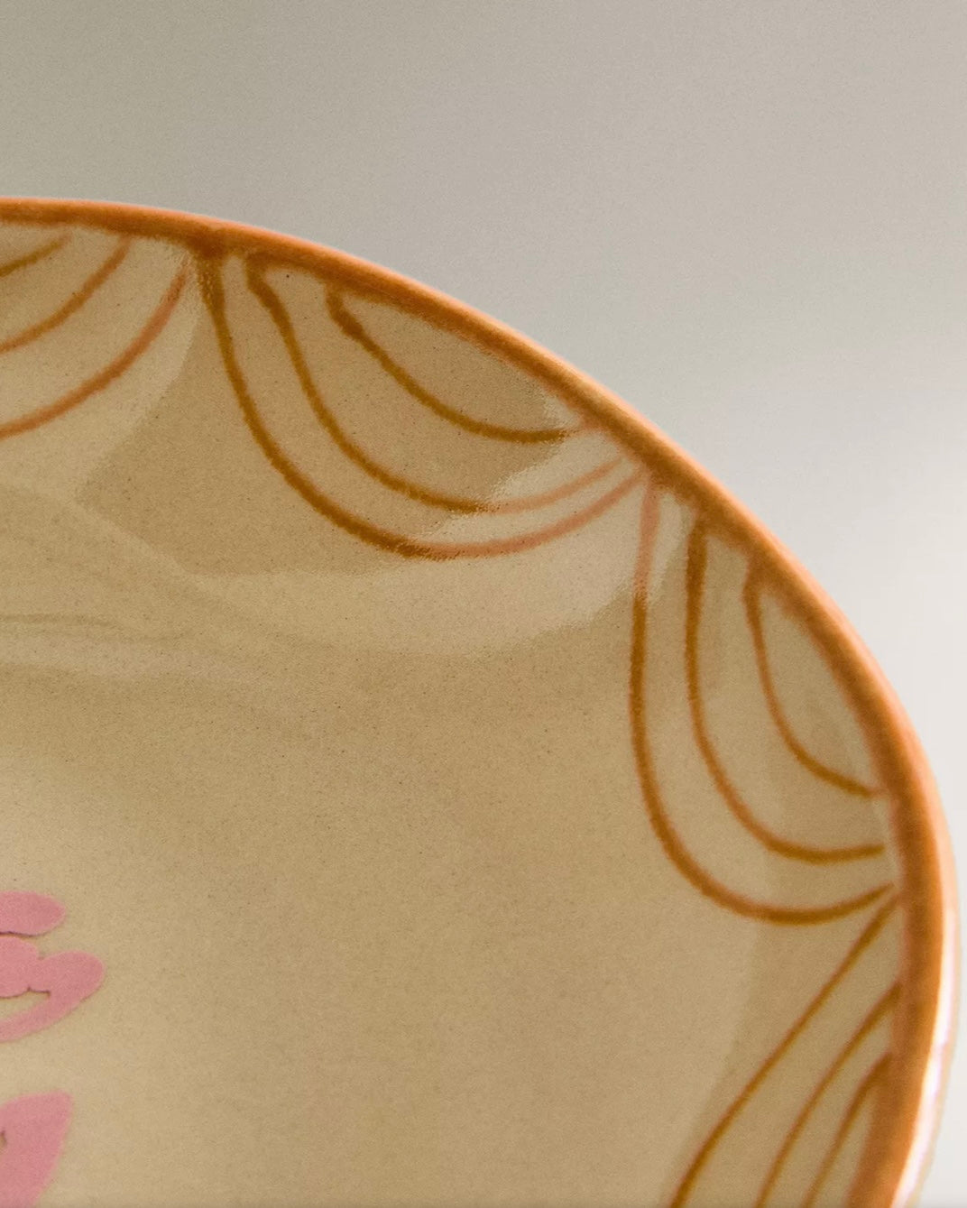 Painted earthware salad bowl by Nanushka, with brown and pink floral design.