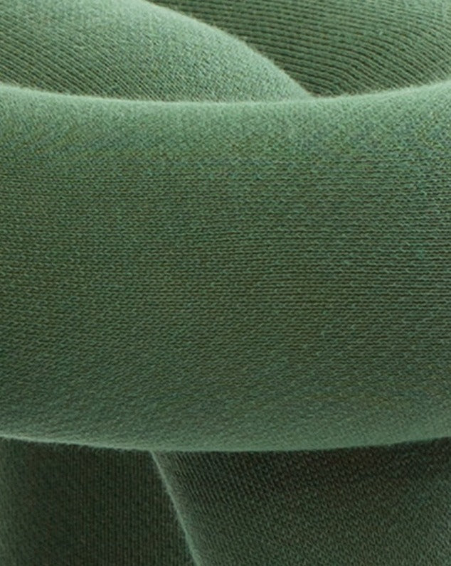 Cropped view of an olive green stool by Moustache, featuring a woven texture.