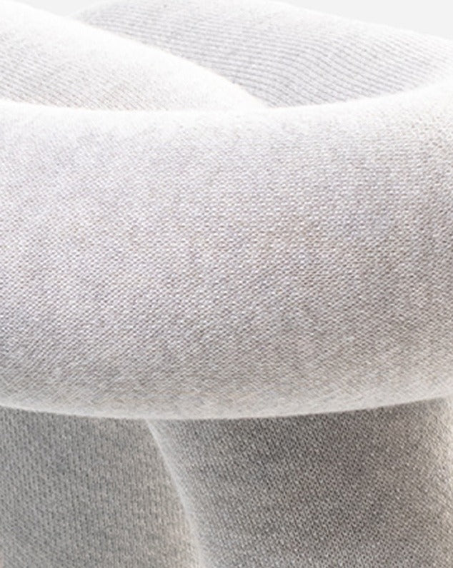 Cropped studio shot of a purple stool from Moustache, showcasing the fabric texture.