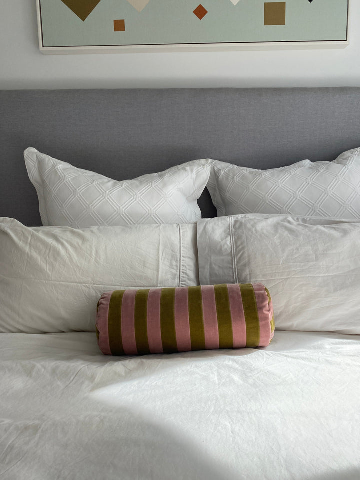 Striped bolster cushion by Christina Lundsteen with pink and green velvet vertical stripes.