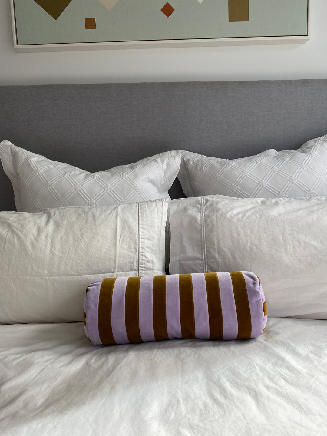 Striped bolster cushion by Christina Lundsteen with brown and light purple vertical stripes.