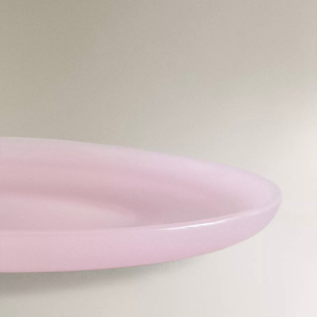 Pink dinner plate by Nanushka, photographed at an angle.
