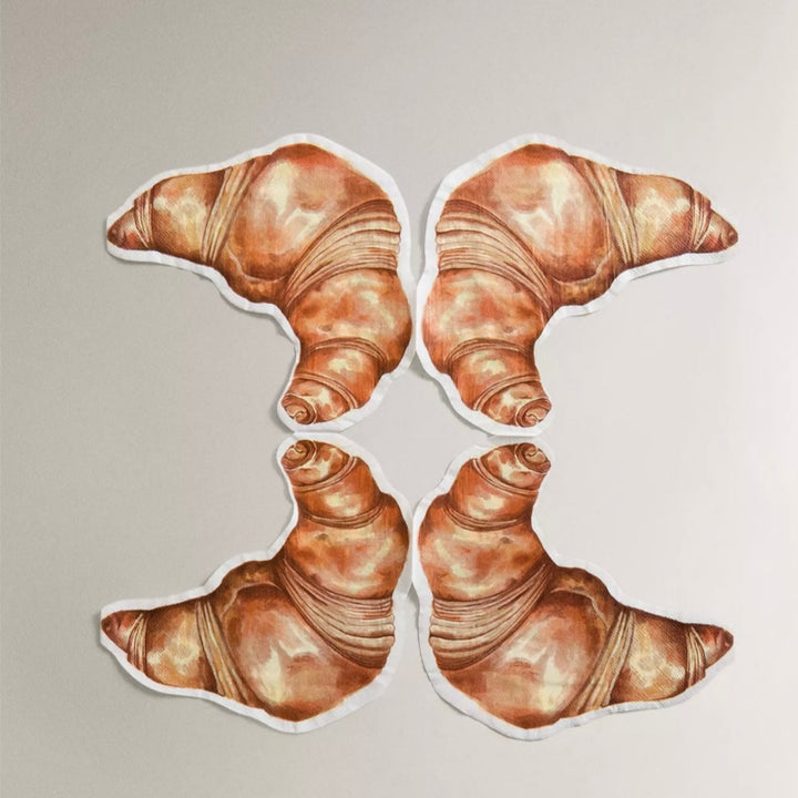 Croissant paper napkins by Avenida Home, arranged in a symmetrical square.