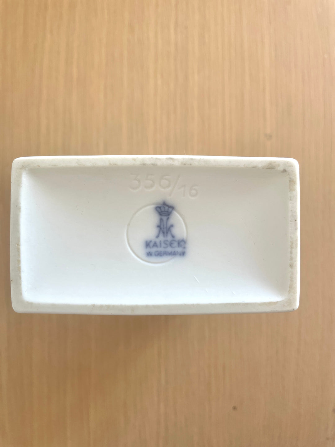 White rectangular porcelain vase by Kaiser, showing the bottom and logo.