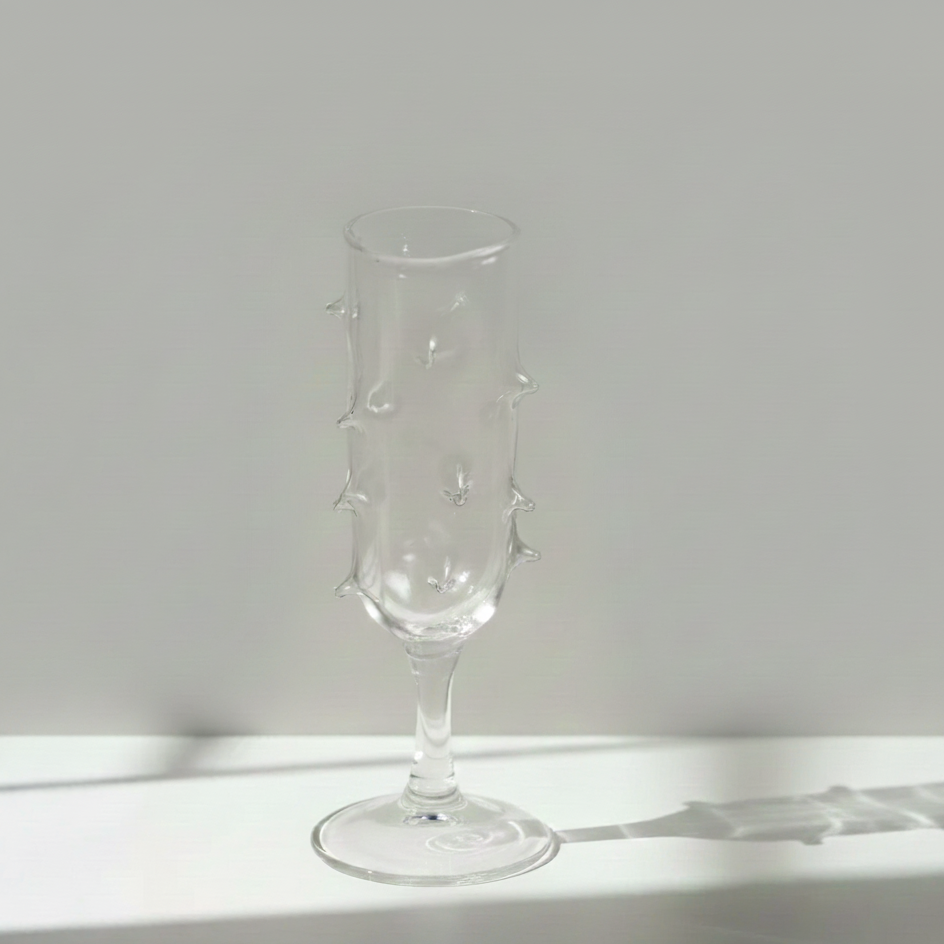 Clear glass with cactus design on a white surface