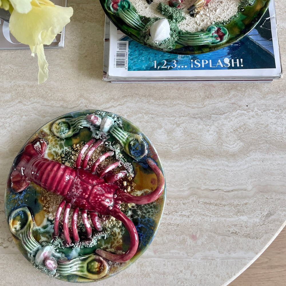 Majolica Palissy ware plate with lobster by Majolica, featuring a red lobster and sea plant details.
