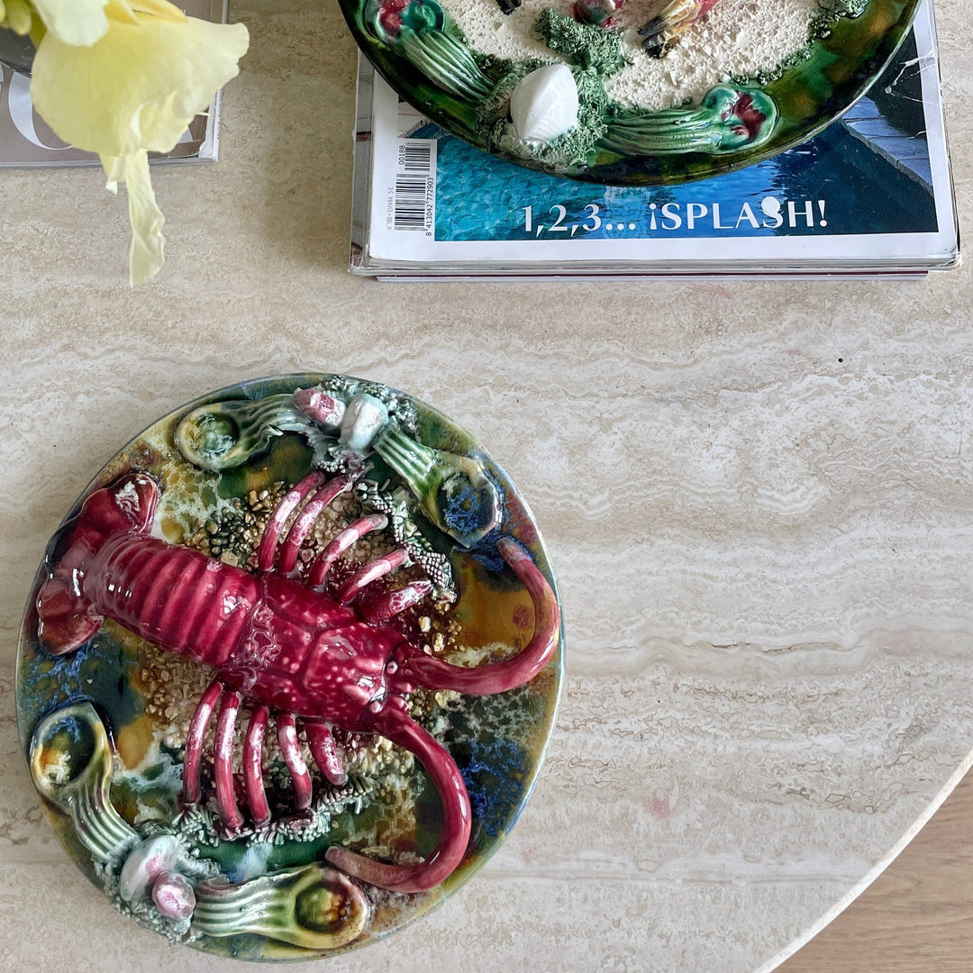 Majolica Palissy ware plate with lobster by Majolica, featuring a red lobster and sea plant details.
