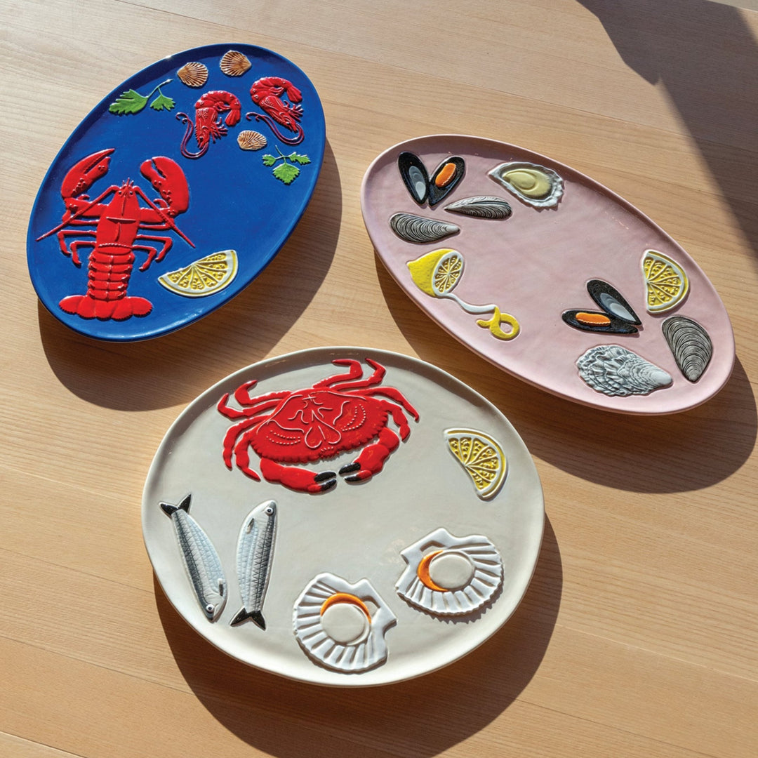 Crab platter by &Klevering featuring a raised marine life pattern on a pale surface.