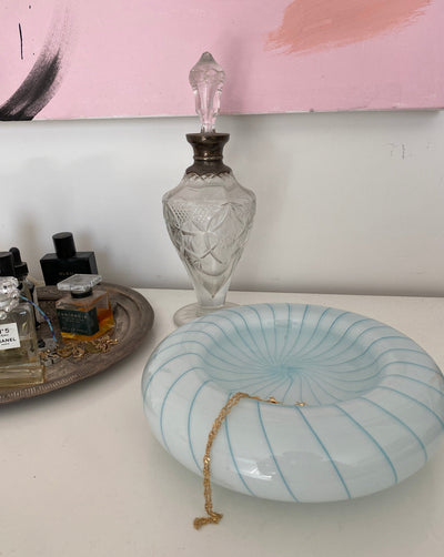 Circular Murano blue and white swirled glass bowl in bedroom