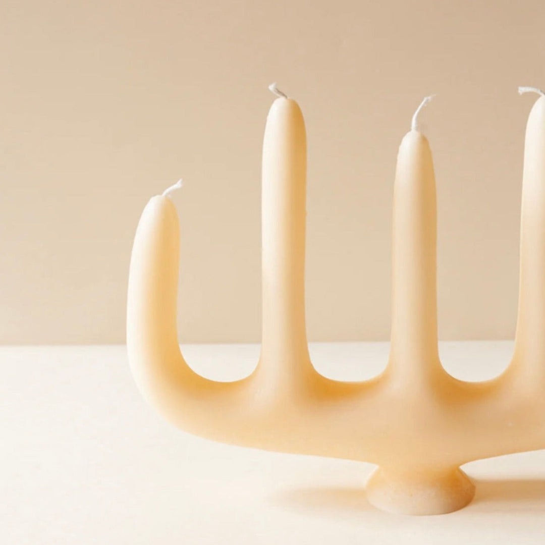 Novel candelabra candle with four arms on matching base.