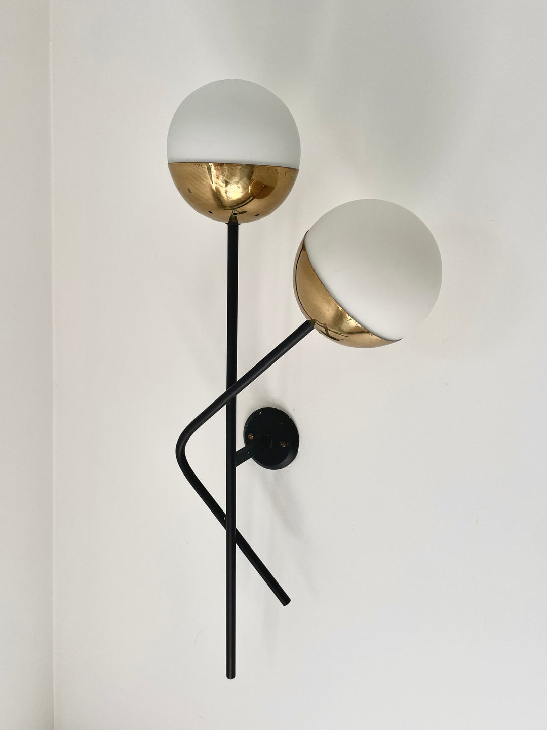 Vintage wall light pair with gold and white accents from Italy, with black metal arms.