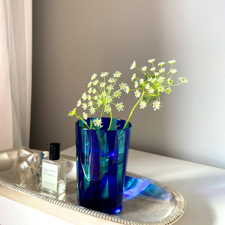 Dark Blue and light blue striped murano drinking glass with flowers in it