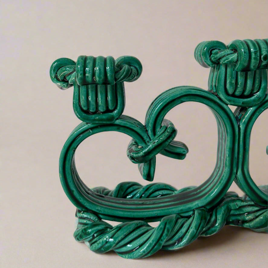 Green ceramic candelabra from Vallauris, France, featuring rope-like texture and decorative knot elements.
