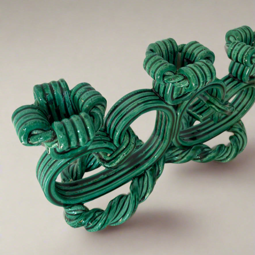 Green ceramic candelabra from Vallauris, France, featuring looped rope design with decorative knots.