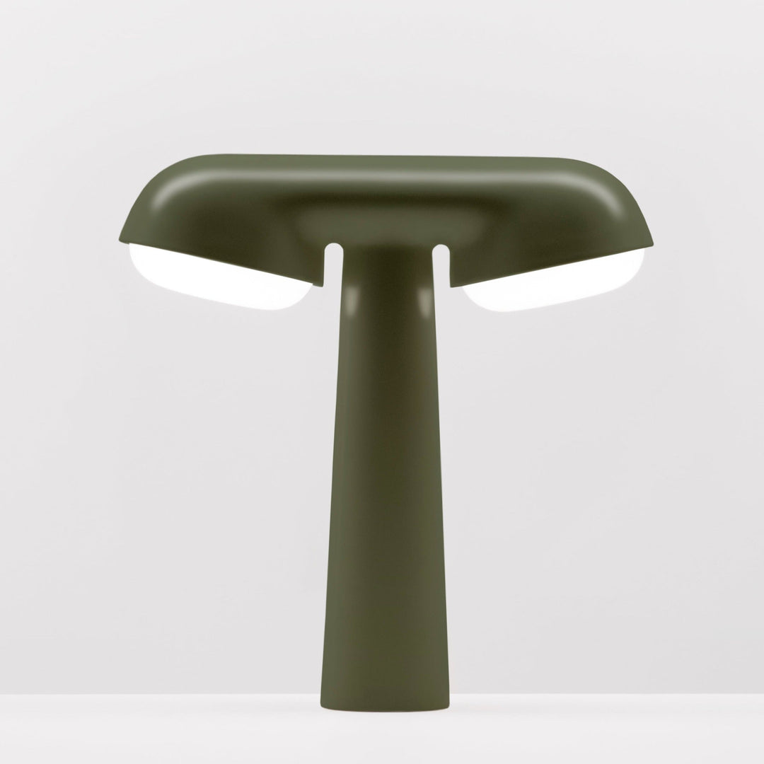 Khaki TGV table lamp by Moustache with bright white light emitting from under the shade.