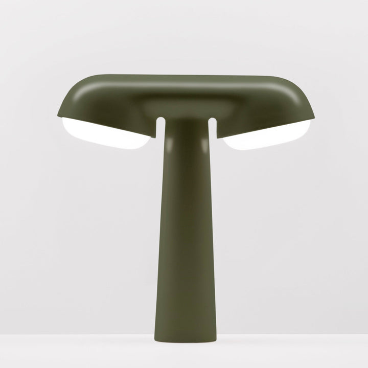 Khaki TGV table lamp by Moustache with bright white light emitting from under the shade.