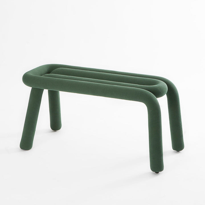 Forest green bench by Moustache, featuring a plush, rounded form with four cylindrical legs.