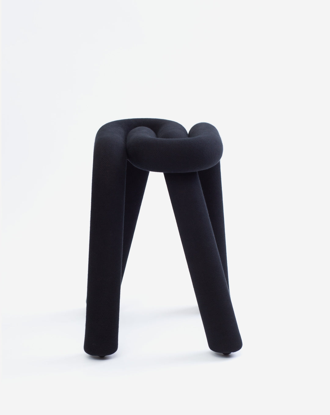 Purple upholstered stool by Moustache, featuring a unique knotted design and cylindrical legs.