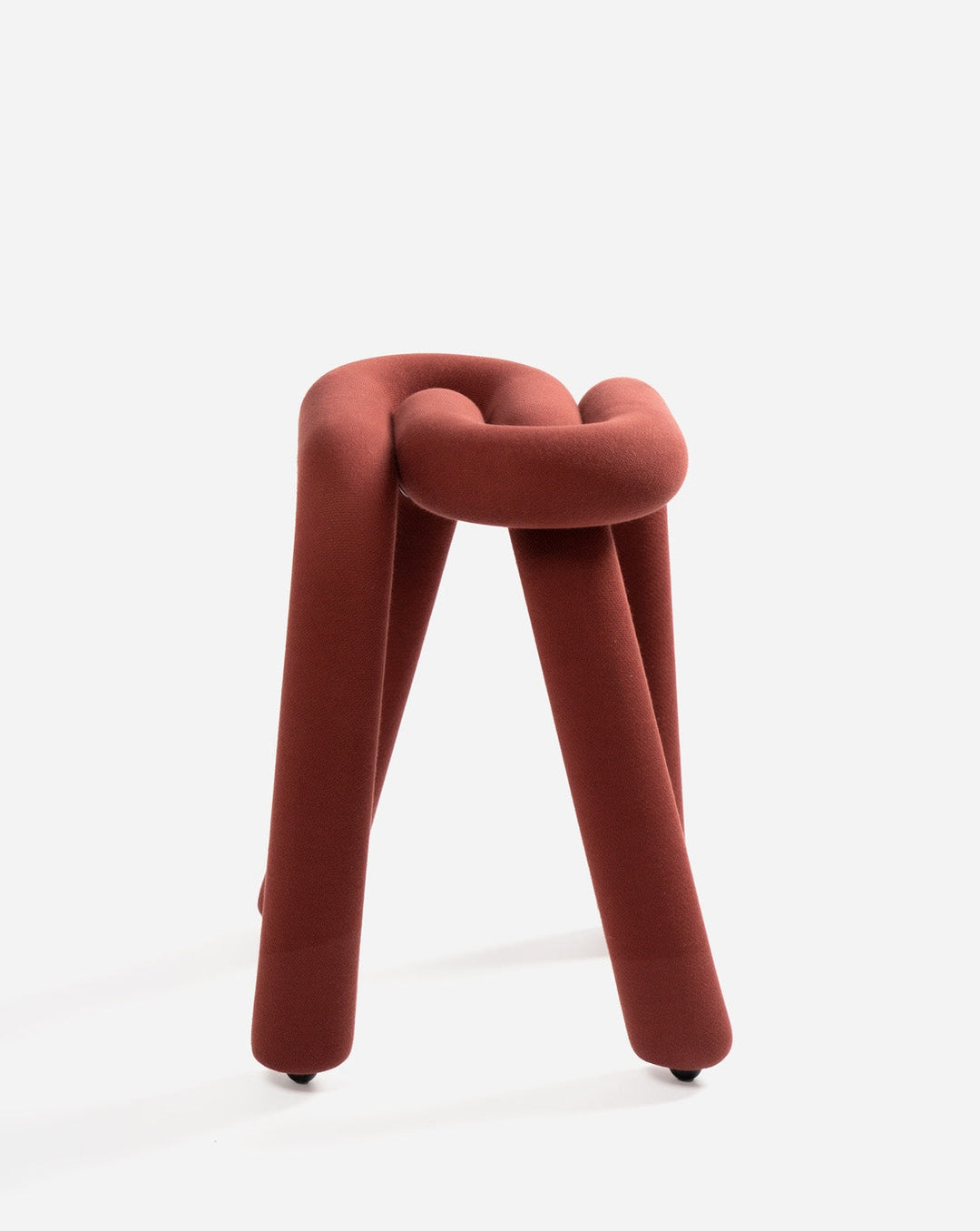 Purple stool by Moustache with a knotted top and three cylindrical legs.