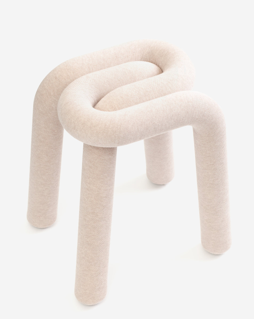 Beige fabric stool by Moustache featuring a coiled top and cylindrical legs on a white background.
