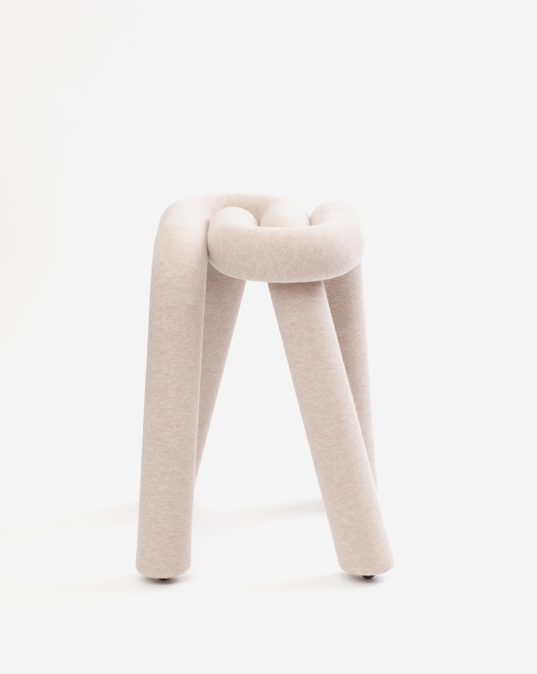 Beige knit stool from Moustache, featuring a looped seat and three cylindrical legs.