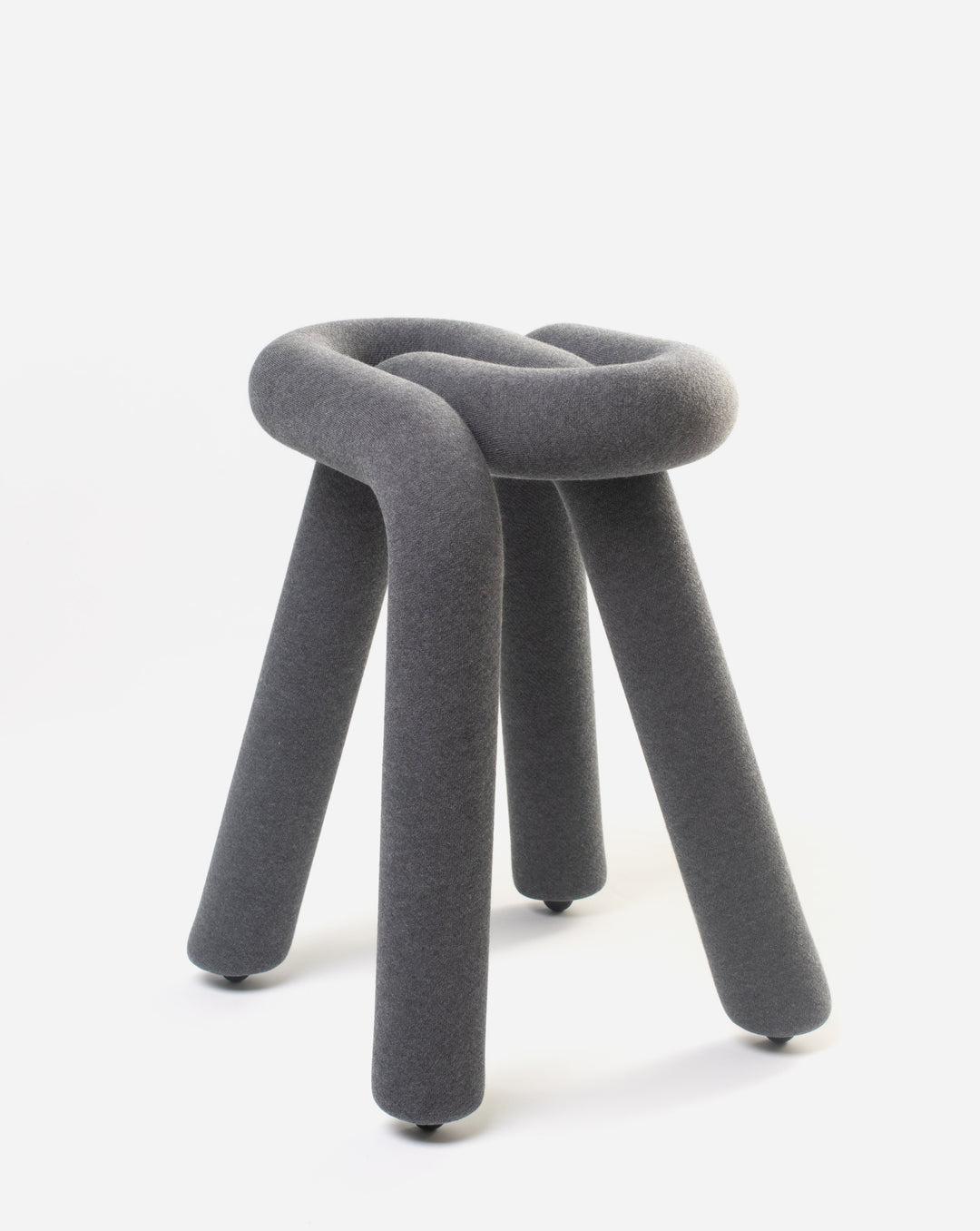 Gray upholstered stool by Moustache with a knotted design and three legs.