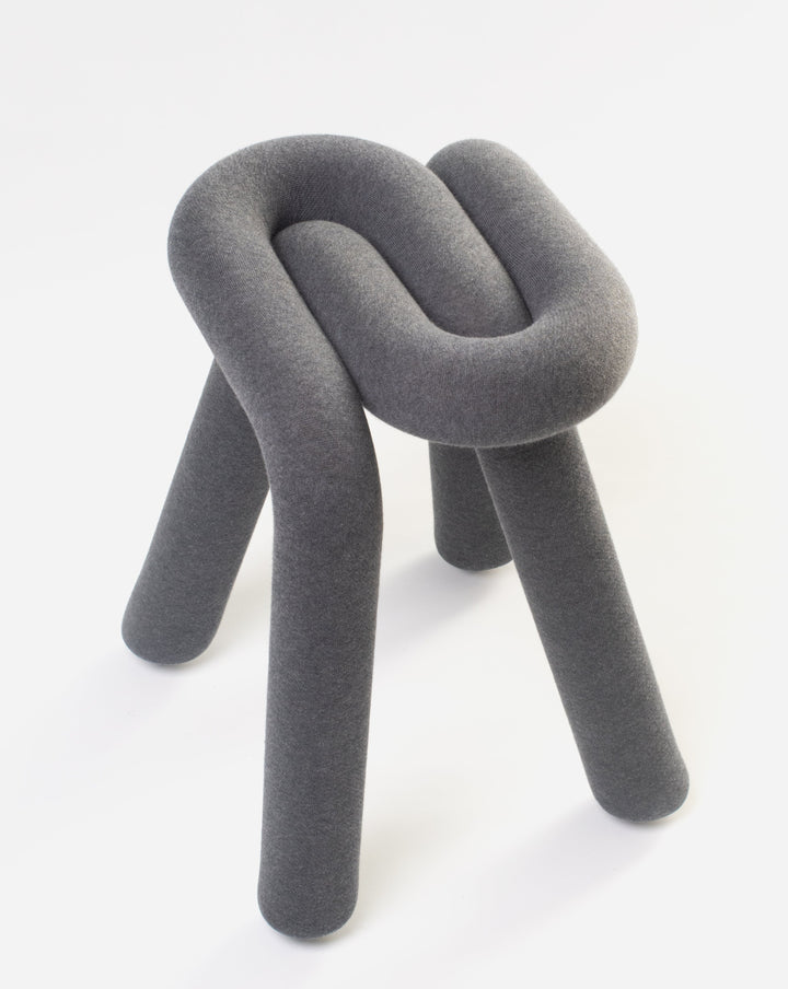 Gray fabric stool by Moustache with a knotted design and three legs.