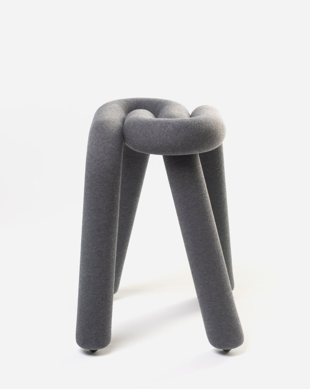 Grey fabric stool by Moustache, with an intertwined tubular design and short cylindrical legs.