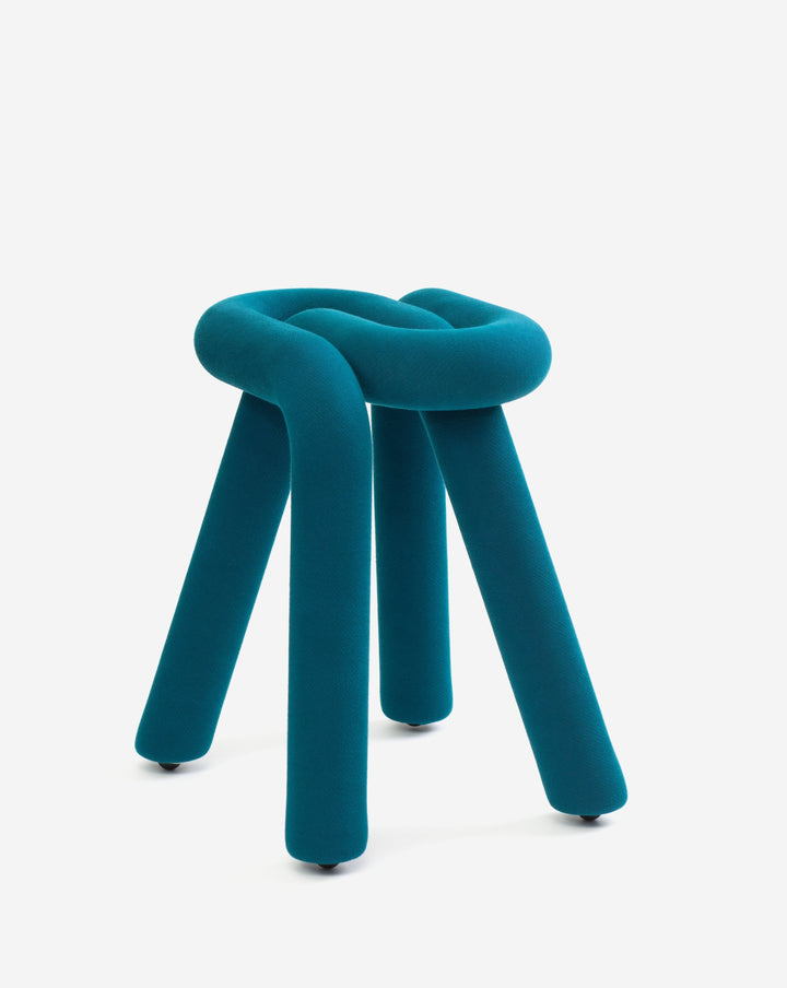 Teal upholstered stool by Moustache with a knotted seat and three cylindrical legs.