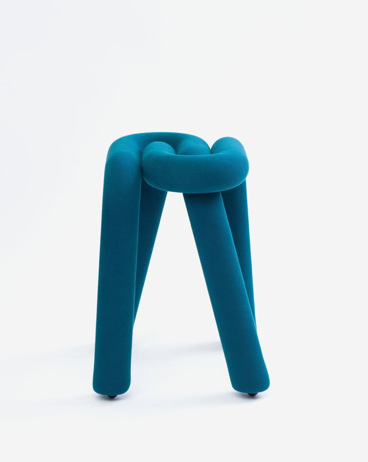 Blue textile knot stool with casters.