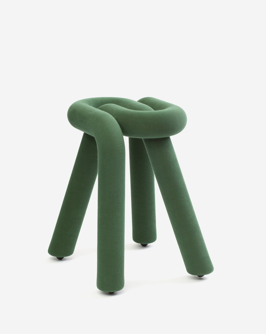 Green fabric stool by Moustache, featuring a knotted seat and cylindrical legs with dark feet, against a plain white background.